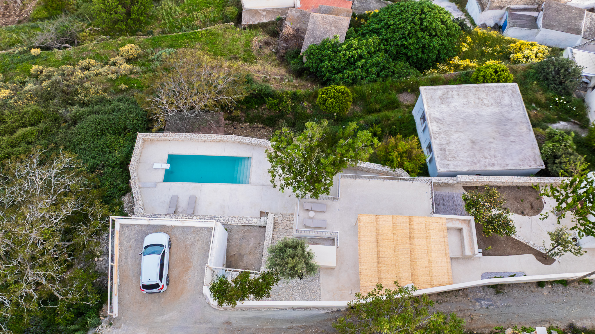 Aerial view showing road, parking, garden, terrace, house, and pool